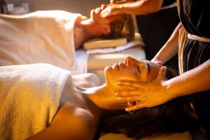 a woman getting a massage in a hospital bed at AMASEA Resort in San Teodoro