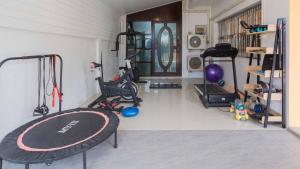 a room with a gym with a surfboard in it at Poolnest Villa Aonang Tranquil Private Retreat in Krabi town