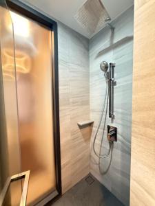 a shower in a bathroom with a glass door at Edge central Pattaya by kansiree in Pattaya +48 photos