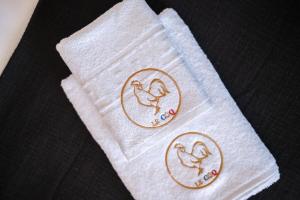 two towels with birds on them on a table at Le COQ Jean Jaurès - Garage XL-AC- Monaco Border in Roquebrune-Cap-Martin