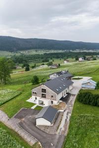 an aerial view of a large building in a field at Le 214, Entre Lacs et Montagnes in Les Rousses