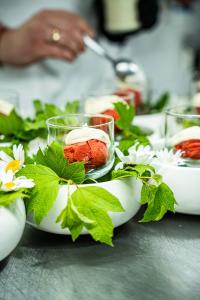 a table topped with bowls of food with flowers at ARCHE Klasztor Wrocław in Wrocław