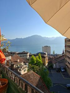 a view of a city from a balcony at Inspiration room, lake, mountains, balcony in Montreux city center in Montreux