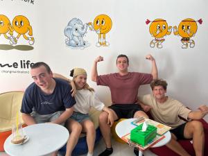 a group of people sitting on a couch in a room at One life Hostel in Chiang Mai