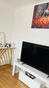 a flat screen tv sitting on top of a white table at Cozy plaza lodge in Rochester