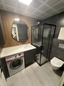 a bathroom with a washing machine and a mirror at Moon City in Antalya