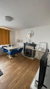 a living room with a table and chairs and a fireplace at Cozy plaza lodge in Rochester