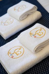 a group of towels with women on them on a table at Le COQ Victoria - Parking - AC - 50m from the sea in Roquebrune-Cap-Martin