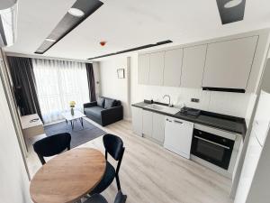 a kitchen and living room with a table and chairs at Moon City in Antalya