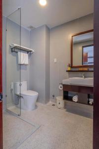 a bathroom with a toilet and a sink and a mirror at Silana River Light Hotel in Da Nang