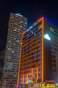 two tall buildings in a city at night at Days Inn & Suites by Wyndham Istanbul in Istanbul