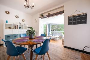 a dining room with a table and blue chairs at Le Coq Saint-Jean - Parking - WiFi - Reposant in Gorbio +29 photos