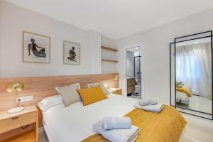 a bedroom with two beds and a mirror at Picasso 2 Royal in Marbella