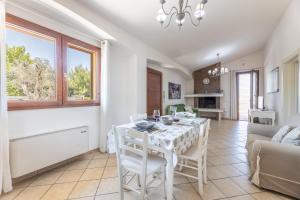 a kitchen and dining room with a table and chairs at Villa Desideria in Matino