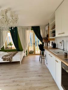 a kitchen and living room with a bed and a sink at Katerina's House in Volimes