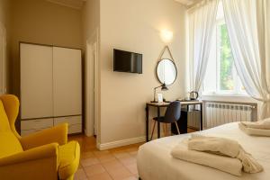 a bedroom with a bed and a desk and a mirror at Palazzo Gargano in Prignano Cilento +101 photos