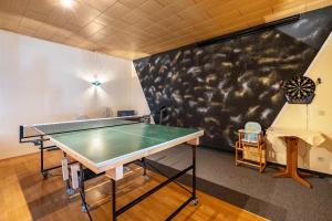 a ping pong table in a room with a chalk wall at Ferienhaus Nestwärme in Werchow