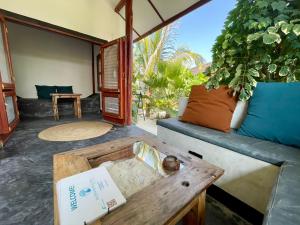 a living room with a couch and a table at Baobab Bungalows in Jambiani