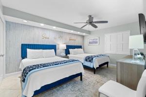 a bedroom with two beds and a ceiling fan at SeaSpray West 203-Gulf Front in Perdido Key +37 photos