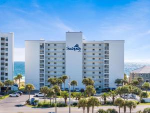 a large white building with a sign on it at SeaSpray West 203-Gulf Front in Perdido Key