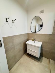 a bathroom with a sink and a mirror at Addo Good Hope Guest House in Sunland +13 photos