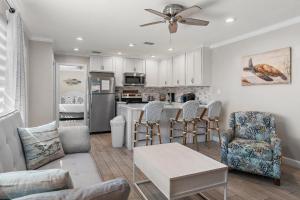 a kitchen and living room with a table and chairs at Capri by the Gulf 122 in Destin