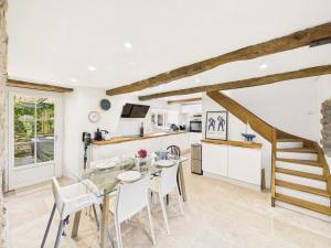a kitchen and dining room with a glass table and chairs at Superbe chaumière pour 6 personnes avec jardin in Ploeren +19 photos
