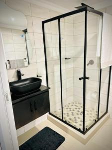 a bathroom with a shower with a black sink at Y & N BnB in Alberton
