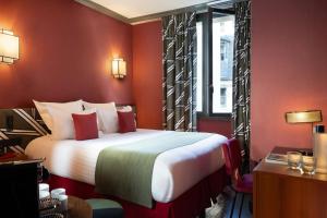a hotel room with a large bed and a window at Hôtel Louvre Piemont & Spa in Paris +31 photos