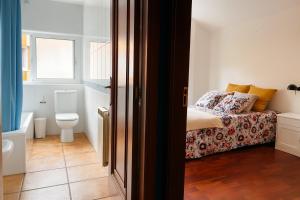 a small bedroom with a bed and a toilet at Casa Vixoi, a 5Km Catedral in Santiago de Compostela +18 photos
