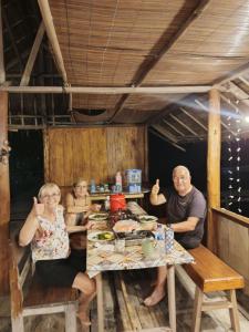a group of people sitting at a table at Senjahomestayrajaampat in Fam +161 photos