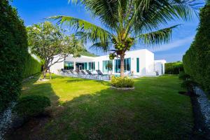 a white house with a palm tree and a yard at Harmony Villa 5 Bedroom Modern Pool Villa - KH-A7 in Khao Tao