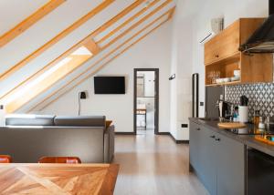 a kitchen and living room with a loft at Limehome Madrid Calle de la Madera - Digital Access in Madrid