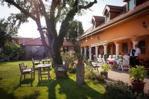 a group of people standing outside of a house at Hárs Fogadó 