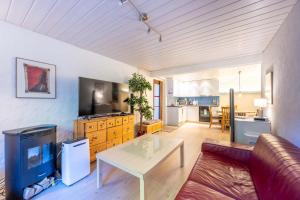 a living room with a couch and a table at Large Apartment In The Vacation Center Whirlpool in Diemtigen