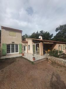 a house with a large yard in front of it at Gîte Léonfine in Le Cannet-des-Maures