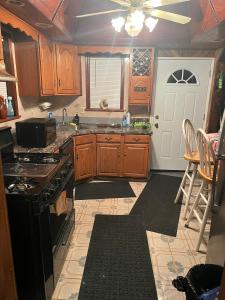 a kitchen with wooden cabinets and a stove top oven at Choice home 2 in West Babylon