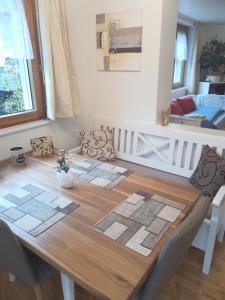 a dining room table with mats on top of it at Garten-Wohnung in Eschen