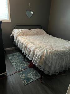 a bedroom with a bed with a white comforter at Choice home 2 in West Babylon +6 photos