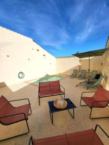 a group of chairs and a table on a patio at Maison de charme avec Piscine-Clim-Plage à 10min in Fleury