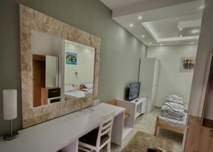 a living room with a large mirror on the wall at Lux A2 in Jošanička Banja