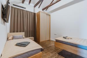 a bedroom with two beds and a mirror at Marmor Collis by Winery Glavica in Gornja Gračenica +44 photos