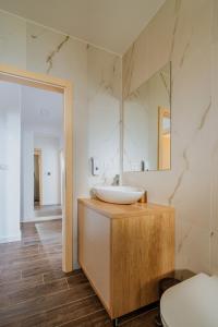 a bathroom with a sink and a mirror at Marmor Collis by Winery Glavica in Gornja Gračenica