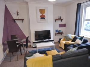 a living room with a couch and a tv at Sigma Elegance Free Parking in Tynemouth +13 photos