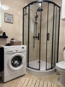 a shower in a bathroom with a washing machine at Villa Rocky View in Stará Lesná +51 photos