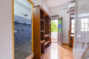 a bathroom with a walk in closet and a glass door at Serendipity Beach Hotel in Unawatuna