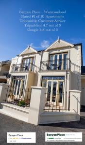 a picture of a white house with a balcony at Banyan Place in Warrnambool