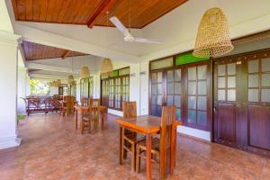 a dining room with wooden tables and chairs at Serendipity Beach Hotel in Unawatuna +66 photos