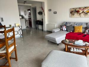 a living room with a couch and a table at Rêver en bord de mer in Saint-Michel-Chef-Chef