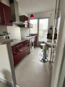 a kitchen with a sink and a stove top oven at Rêver en bord de mer in Saint-Michel-Chef-Chef
